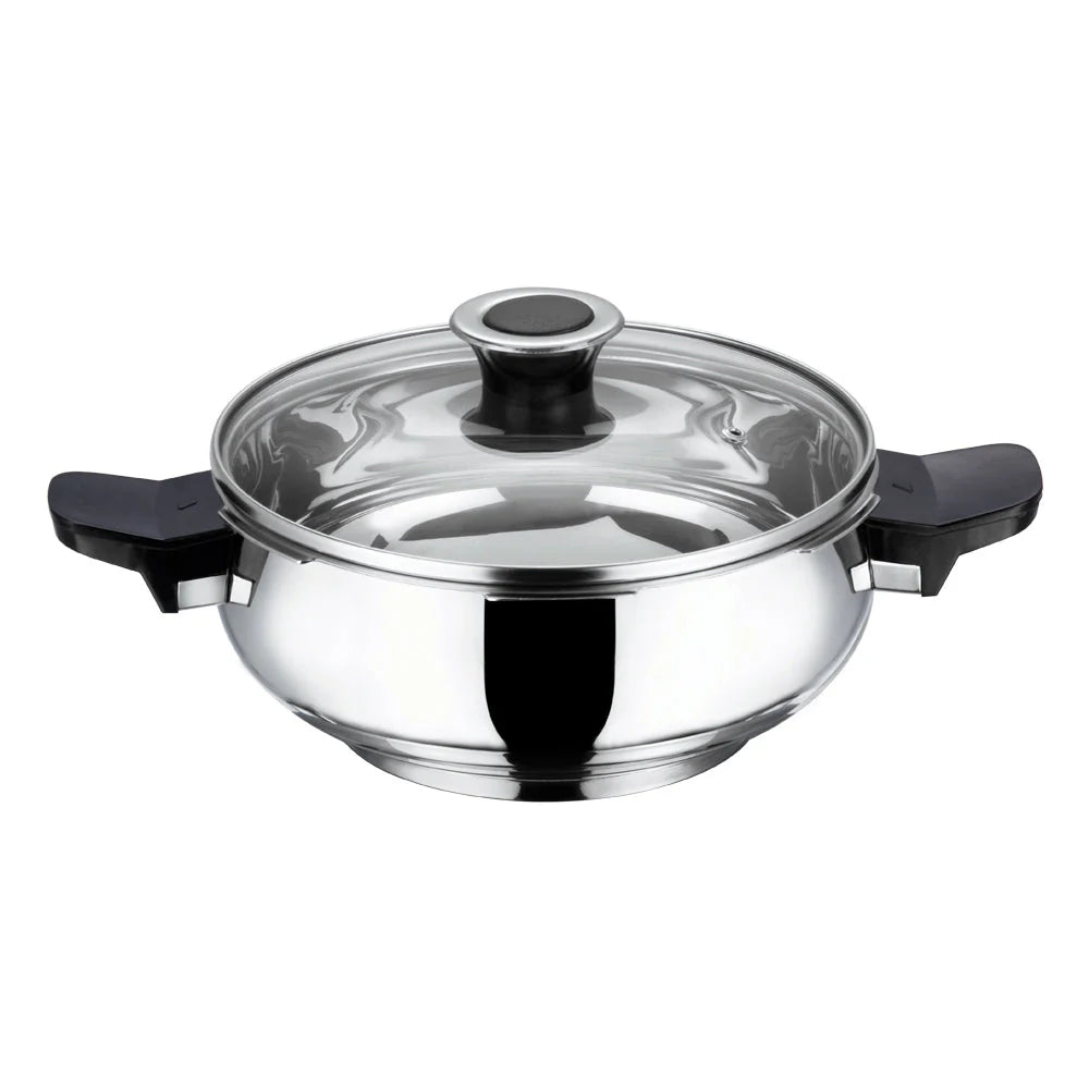 Stainless steel pressure cooker with glass lid on a white background