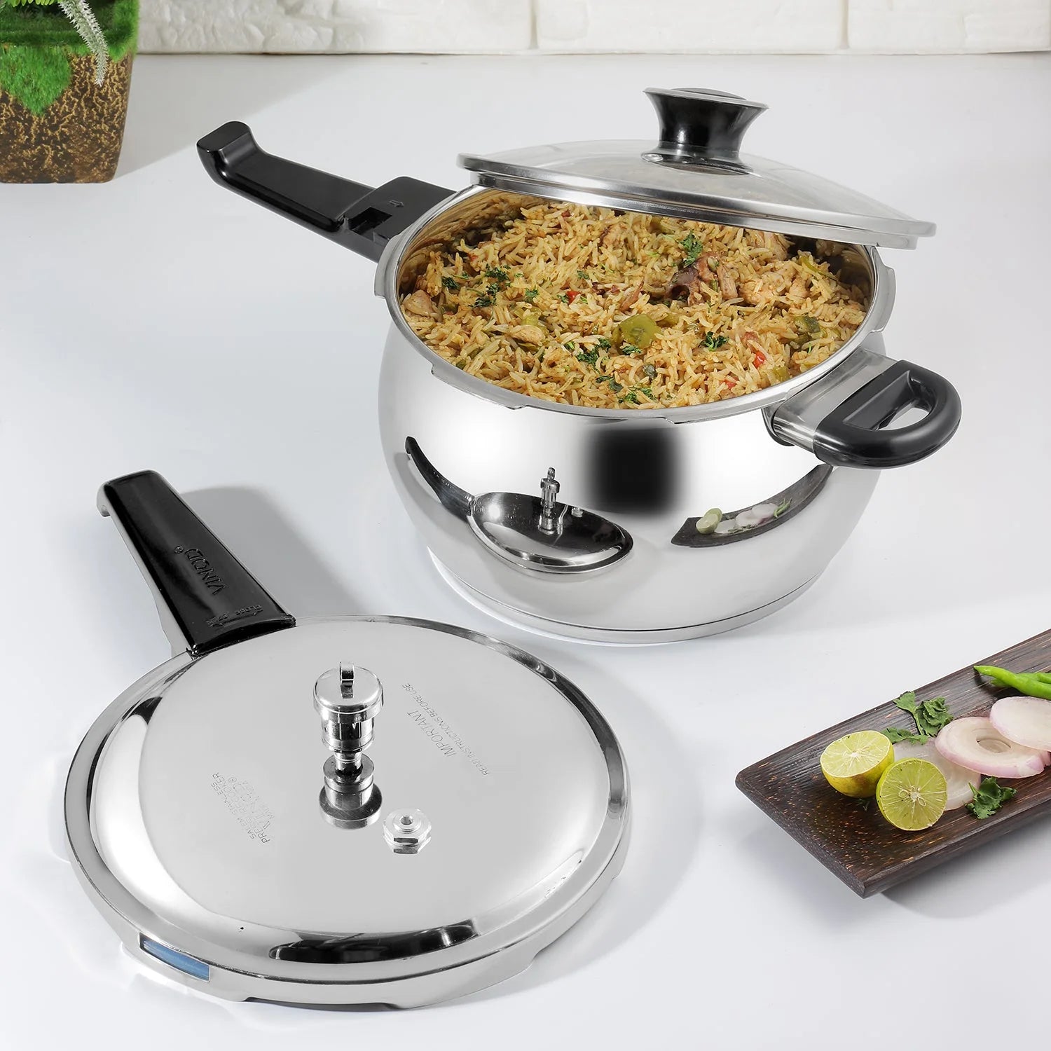 5.5 Liters Stainless steel pressure cooker with food on a white surface