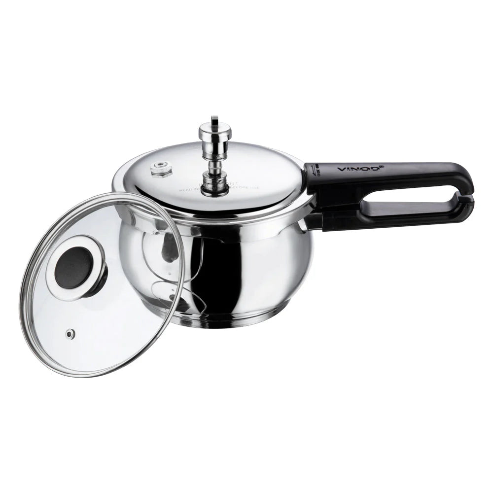 Stainless steel pressure cooker with glass lid on a white background