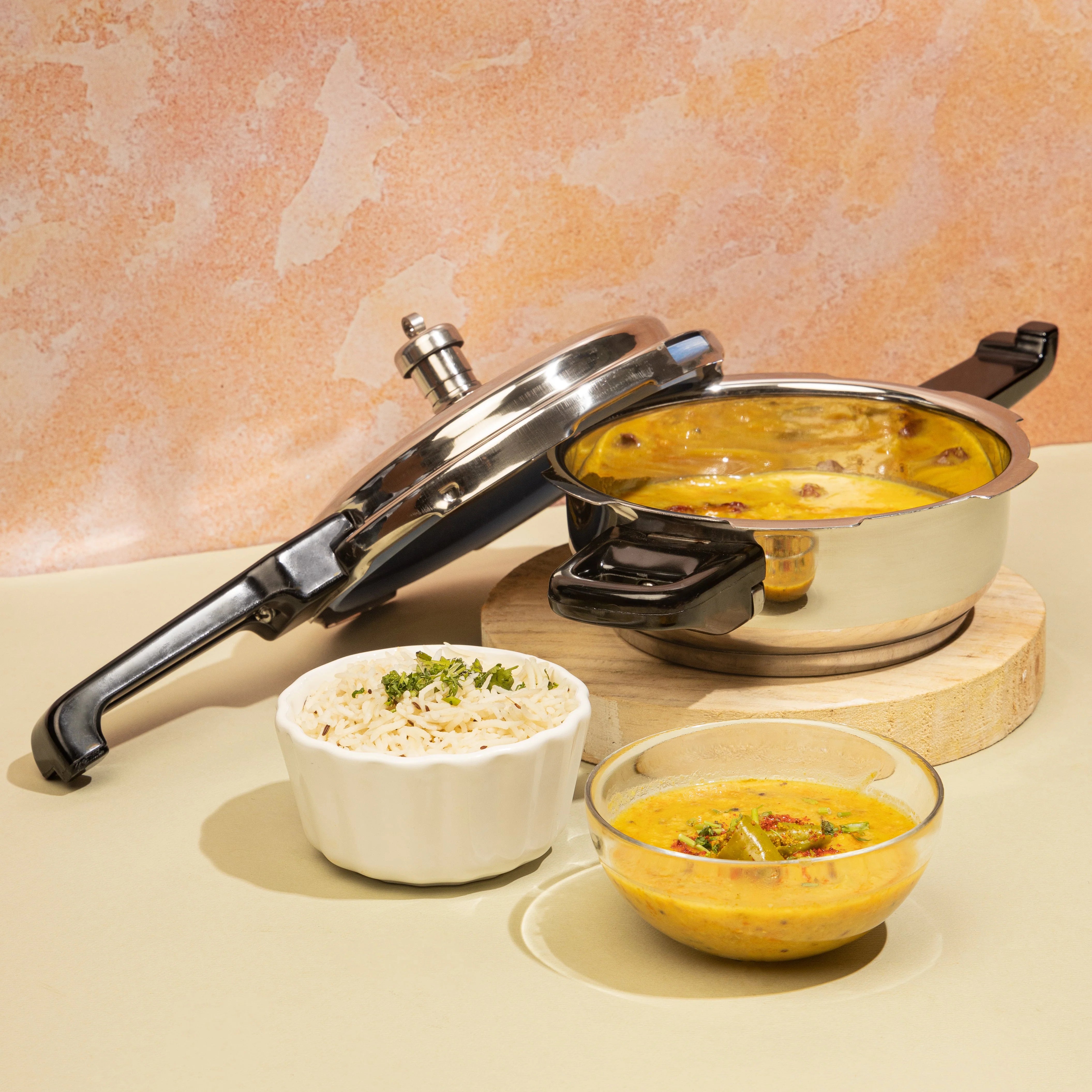 Pressure cooker with food on a wooden board