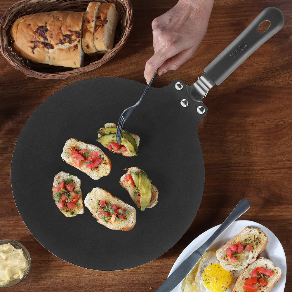 Vinod Hanos Non Stick Flat Multi Tawa with cooking bread on it