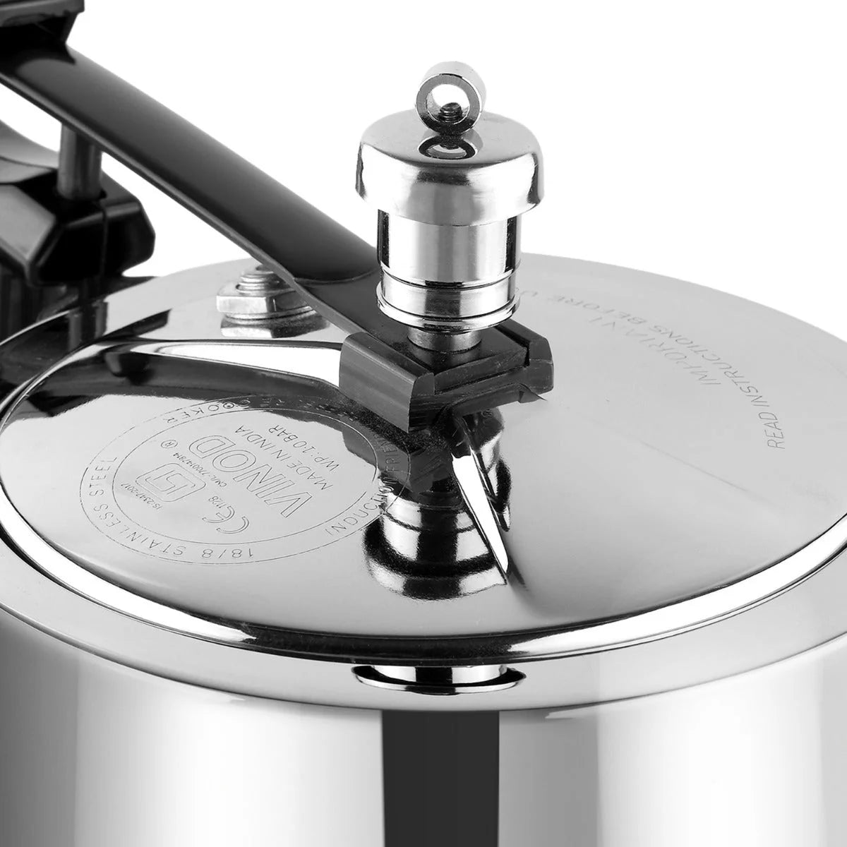 Close-up of a pressure cooker lid with a brand logo and pressure regulator 