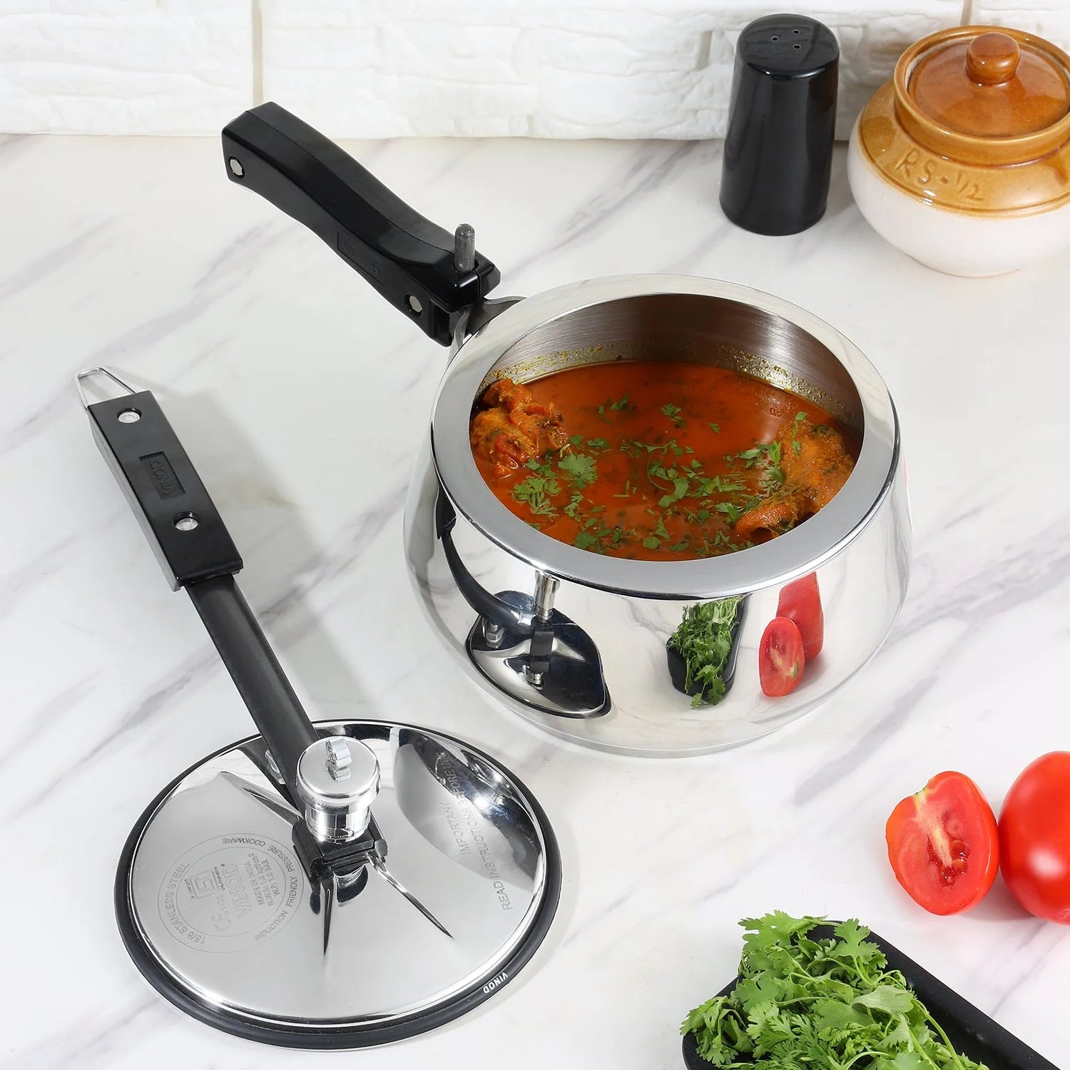 3 liters Stainless steel pressure cooker with food on a kitchen counter
