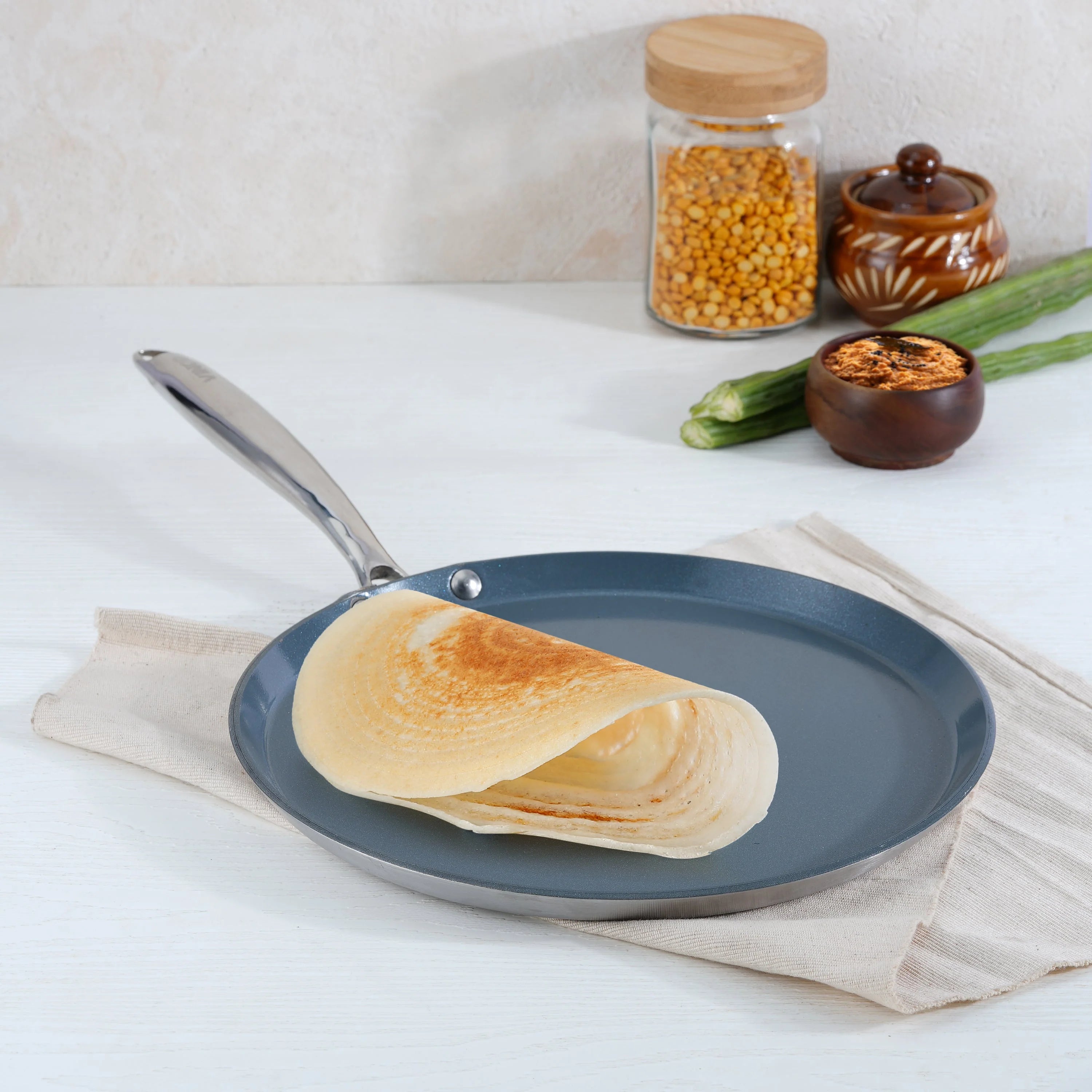 Perfect golden dosa being cooked on Vinod Platinum SAS Ceramica Dosa Tawa showing excellent food release and even browning