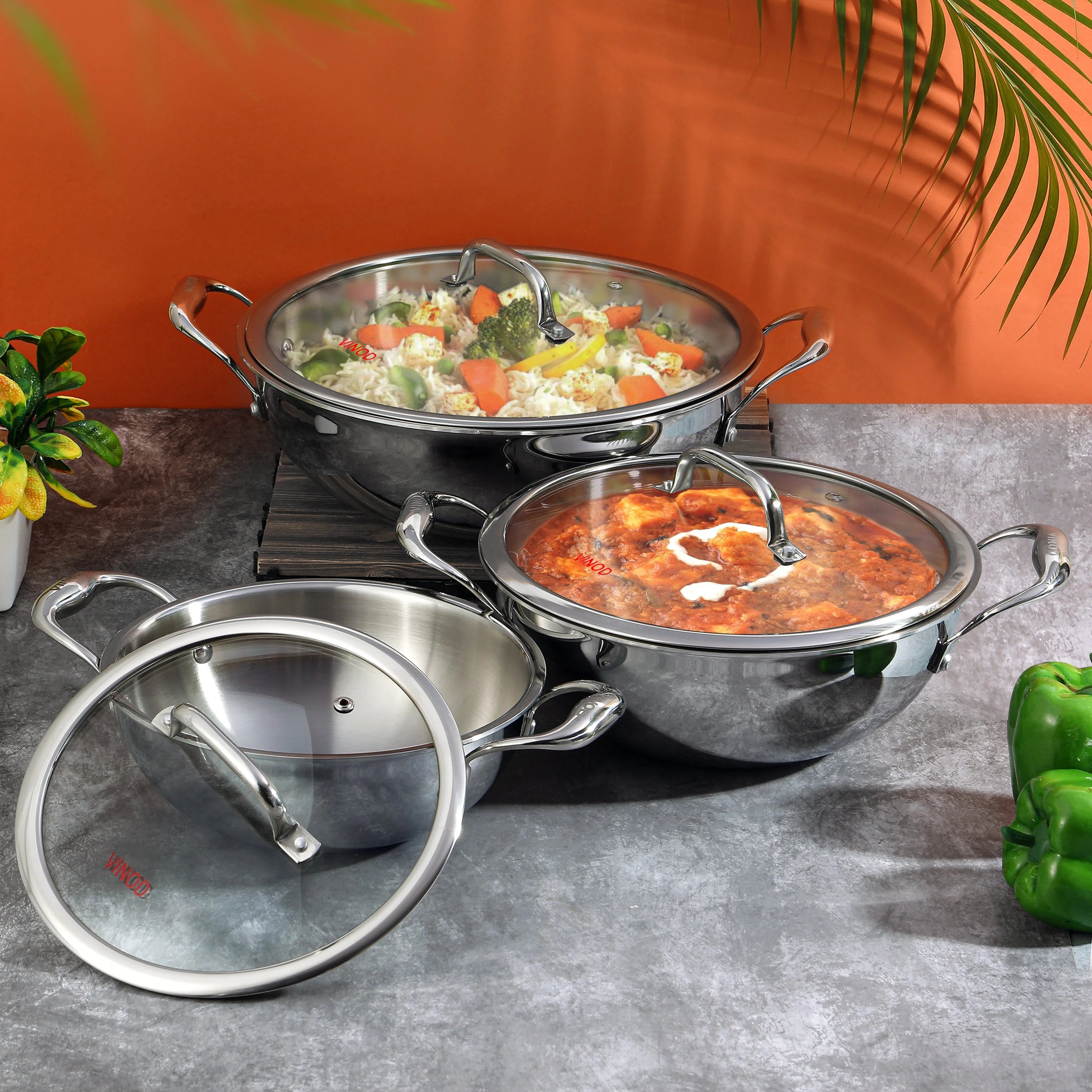 Vinod Platinum triply stainless steel kadai collection with vegetable biryani, butter paneer masala, and extra deep design for authentic Indian cooking
